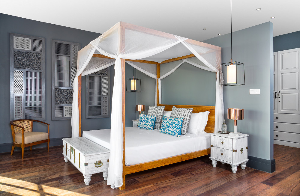 A four-poster bedroom open to the sea breeze
