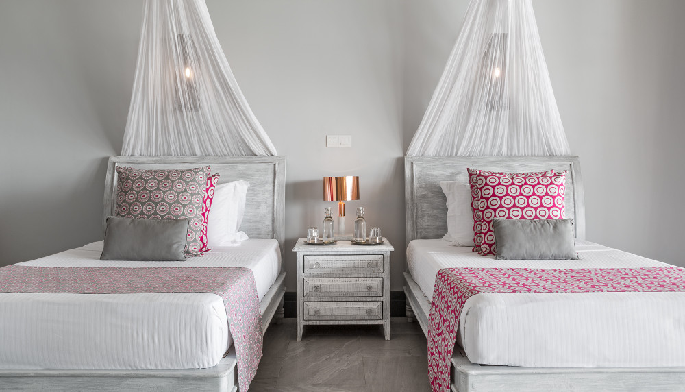 A twin bedroom open to the garden